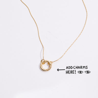 &LIVY Expandable Intention Chain Charm Necklace in gold showing interlocking ring clasp with text Add Charms Here and arrow pointing to charm holder on delicate gold chain