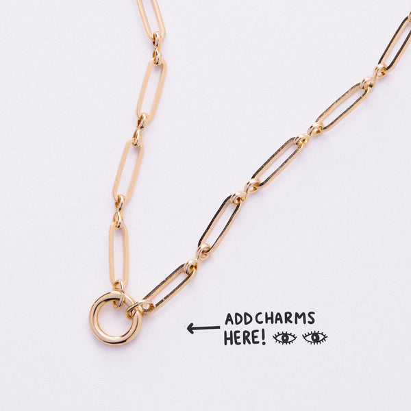 &LIVY Paperclip Intention Chain in finely finished gold showing paperclip links and round charm holder ring with text Add Charms Here and arrow pointing to charm holder