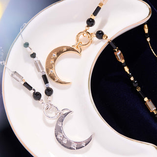 Close-up of genuine onyx beads and crescent moon charm on patented adjustable slider necklace