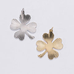&LIVY Shine On Clover Charm in both silver and gold four-leaf clover pendants with radial sunburst texture