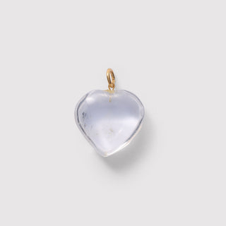 Heart-shaped crystal pendant on a light gray background