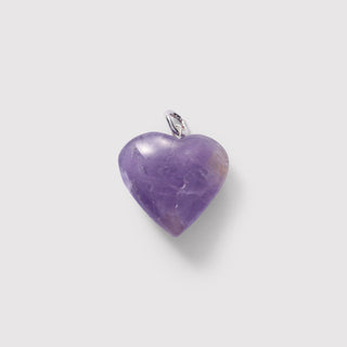 Heart-shaped purple pendant on a light gray background