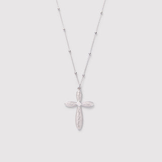 Silver cross necklace on a light gray background
