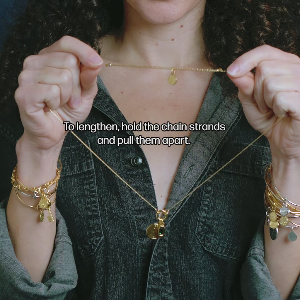 Video showcasing &LIVY Renewed Love Expandable Necklace Set with Good Luck Token Charm and emerald crystal pendant